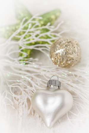 Christmas decoration with white heart and light green colors, soft focus, verticalの写真素材