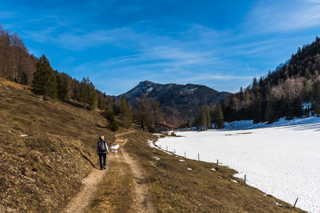 Alpine landscape at the end of winter, partly covered with snow, copy spaceの写真素材