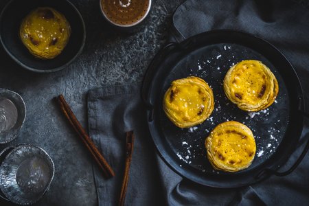 Traditional portuguese dessert, pastel de nata, pasteis de nata, egg tart, on dark gray background, top viewの写真素材