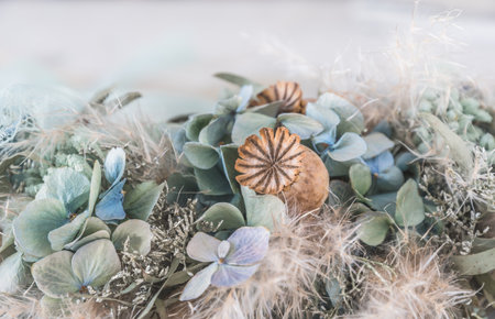 Close-up of a wreath of dried flowers in light green and white winter colorsの写真素材