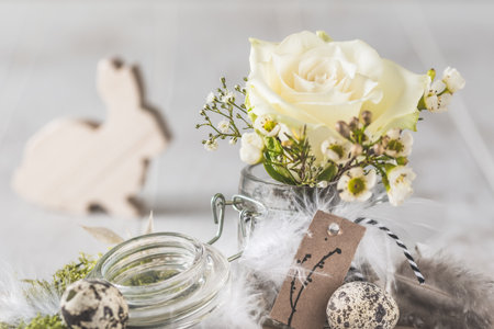 Mini hyacinth in mason jar decorated with feathers and easter bunny, spring or easter decorationの写真素材