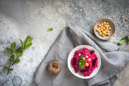 Bowl with beetroot hummus on a rustic gray background, top view, copy spaceの写真素材
