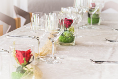 White table setting with rose decoration for a celebrationの写真素材