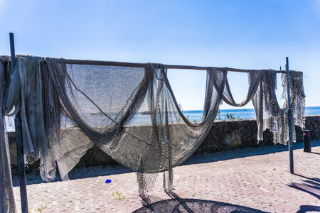 Fishing nets hanging in the sun to dryの写真素材