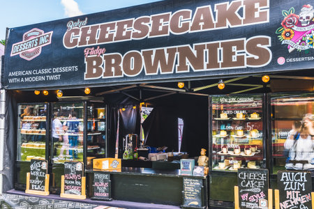 Hockenheim, Germany - May 18, 2023: Market stall with brownies and cheesecake desserts. Street...
