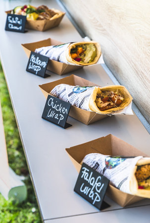 Assorted wraps with price tag on a food truck at the festivalの写真素材