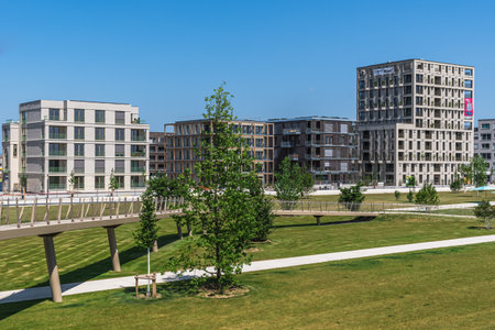 Mannheim, Germany - May 26, 2023: View from the grounds of the Federal Horticultural Show (Bundesgartenschau) to newly constructed blocks of flats, concept for modern urban living. Copy space.のeditorial素材