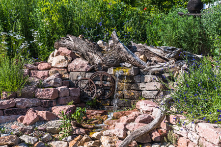 Natural garden with stones, old wood and watercourseの写真素材