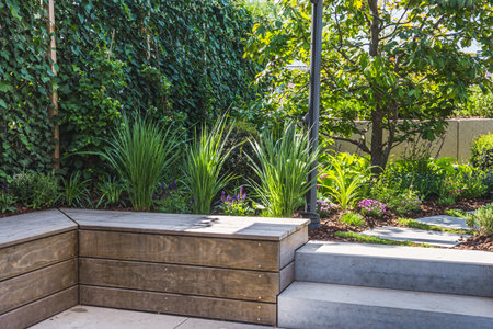 Cozy shady seating area made of concrete and wood in a gardenの写真素材