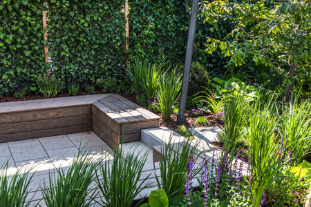Cozy shady seating area made of concrete and wood in a gardenの写真素材