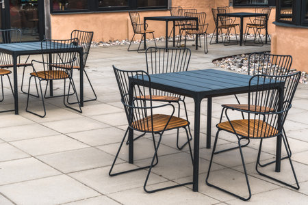 Modern metal and wood table and chairs in a cafeの写真素材