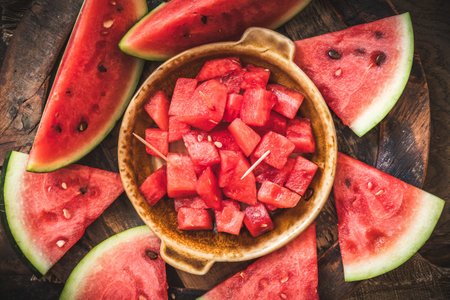 Sliced and chunky fresh watermelon on rustic wooden background, top viewの写真素材