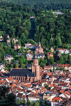 View of German city Heidelberg with old city and Church of the Holy Spirit (German: Heiliggeistkirche) on a sunny summer evening, verticalの写真素材