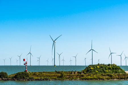 Wind turbines in the IJsselmeer not far from the beach