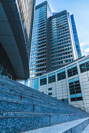 Modern buildings with glass facades and wide staircase, blue colors, verticalの写真素材