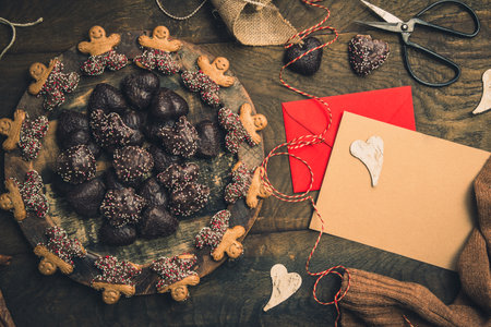 Scene for gifts in Advent with cookies, gift ribbon and card for text on dark wooden back ground, Christmas concept. copy space, top viewの写真素材