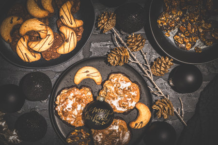 Cookies, gingerbread and Christmas decoration, black and gold, top viewの写真素材