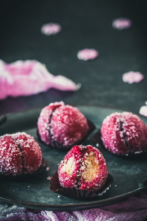Italian pastries with hazelnut filling, called Pesche alla Nocciola, vertical, dark backgroundの写真素材
