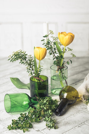 Candlesticks and vases on a white background, decoration made from green wine bottles, craft tip verticalの写真素材