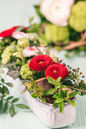 Beautiful arrangement of spring flowers in a gray stoneware bowl, spring or easter decoration, verticalの写真素材