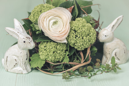 White rose with spring flowers, spring or easter decoration, green backgroundの写真素材