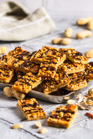 Homemade cookies with salted caramel and peanuts, cut into rectangles