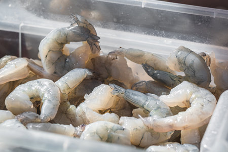Raw shrimps in a box, preparation at an Asian street food stallの写真素材
