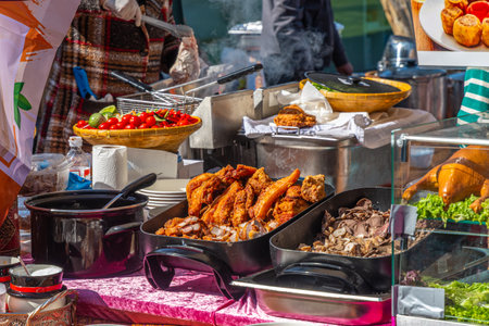 Colorful Asian street food market stall with a selection of fried and boiled meats, street food festivalの写真素材