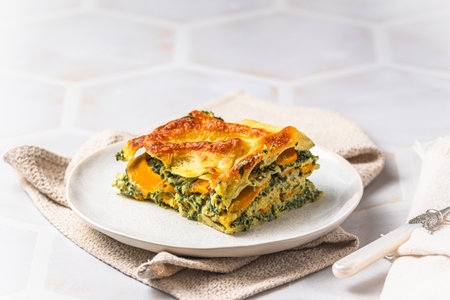 Homemade vegetarian lasagne with pumpkin, spinach and bechamel sauce, copy spaceの写真素材