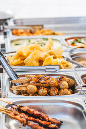 Skewers of Thai meatballs at a food stand, Thai street food, verticalの写真素材