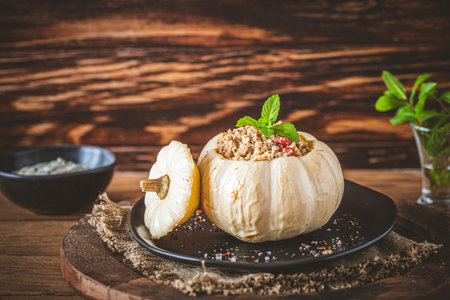 Stuffed mini pumpkin with couscous filling on wooden background.の写真素材