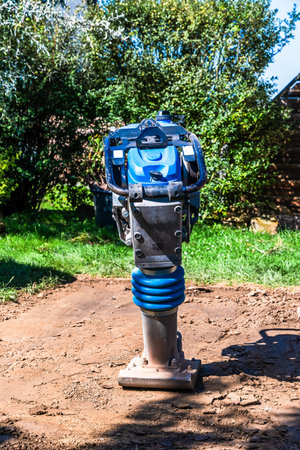 Compactor to firm soil in the garden.