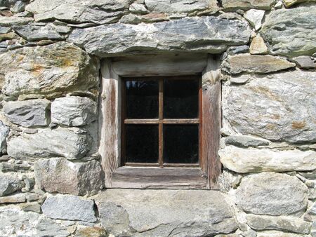 window in wall of stoneの写真素材