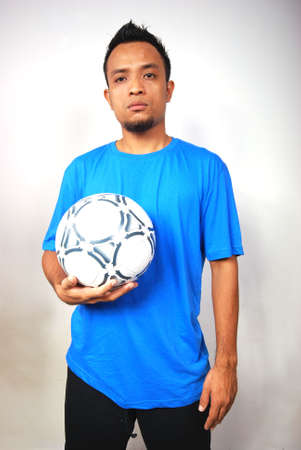 A male football player. Portrait studio shot.の写真素材
