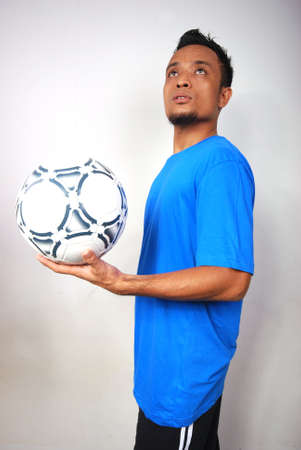 A male football player. Portrait studio shot.の写真素材