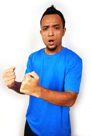 Young man holding her arms in celebrationの写真素材