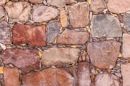 Background of a wall of terracotta colored stones.の写真素材
