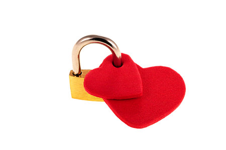 Two red hearts joined together with a padlock as a concept of union and marriage.の写真素材