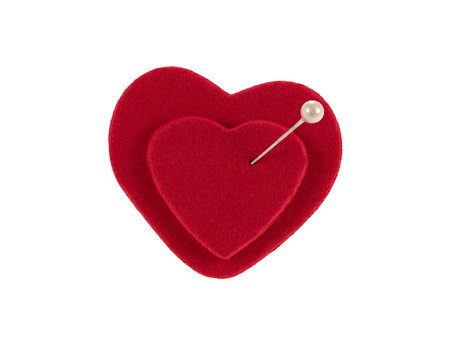 Two red hearts joined by a pin as a concept of marriage and eternal love.の写真素材