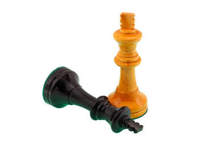 White chess king shown victorious over a fallen and defeated black king.の写真素材
