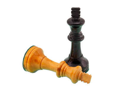 Black chess king shown victorious over a fallen and defeated white king.の写真素材