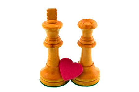 White chess figures, king and queen with a red heart in concept of love, marriage and fidelity.の写真素材