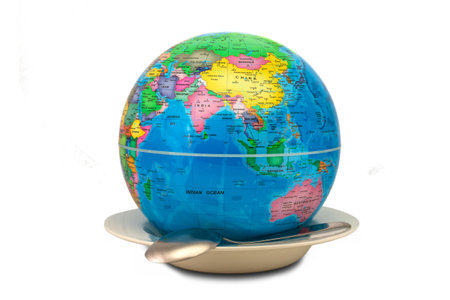 Earth globe inside an empty plate showing Asia and Australia as a concept of world hunger. The empty plate symbolizes the lack of food and the world hunger as a global evil.の写真素材