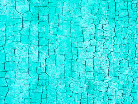 old blue paint on the wall cracked from time to time