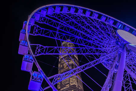 Ferris wheel and skyscraper near Central Ferry pear, Hong Kongの写真素材
