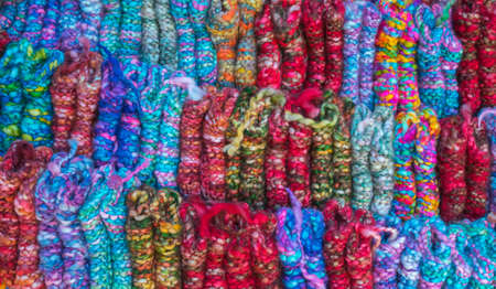 Bright oriental coloured cloth fabric background from Nepal and Indiaの写真素材