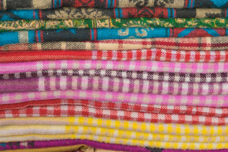 Bright oriental coloured cloth fabric background from Nepal and Indiaの写真素材