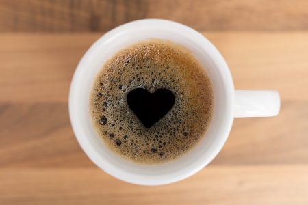 Cup of coffe with heart shape in foamの写真素材