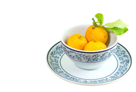 orange in the cup isolated on white backgroundの写真素材