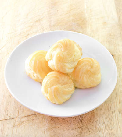 Choux Cream, Cream puff on wooden table, selective focus and vintage effect style